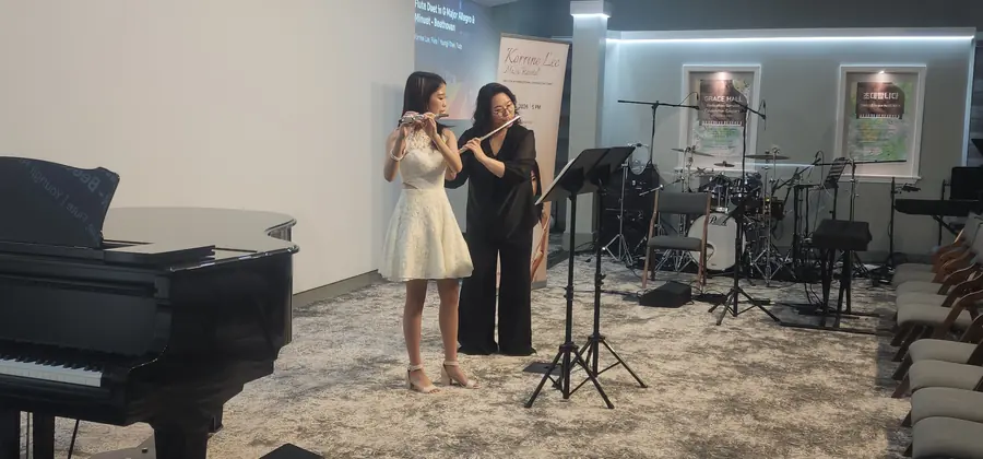 Korrine performing with another musician at the benefit recital