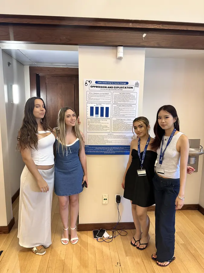 Korrine with fellow students in front of a research poster